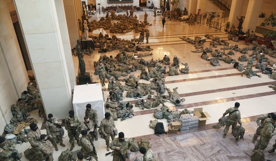 Hundreds of National Guard troops hold inside the Capitol Visitor&#39;s Center to reinforce security at the Capitol in Washington, Wednesday, Jan. 13, 2021. The House of Representatives is pursuing an article of impeachment against President Donald Trump for his role in inciting an angry mob to storm the Capitol last week. (AP Photo/J. Scott Applewhite)
