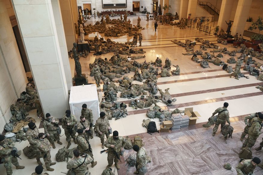Hundreds of National Guard troops hold inside the Capitol Visitor's Center to reinforce security at the Capitol in Washington, Wednesday, Jan. 13, 2021. The House of Representatives is pursuing an article of impeachment against President Donald Trump for his role in inciting an angry mob to storm the Capitol last week. (AP Photo/J. Scott Applewhite)