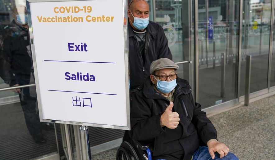 A senior citizen gives the thumbs up as he leaves a New York State COVID-19 vaccination site at the Jacob K. Javits Convention Center after receiving his first dose, Wednesday, Jan. 13, 2021, in New York. New York state expanded COVID-19 vaccine distribution Tuesday to people 65 and over, increasing access to an already short supply of doses being distributed. (AP Photo/Mary Altaffer)