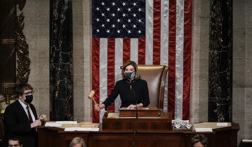 Speaker of the House Nancy Pelosi, D-Calif., leads the final vote of the impeachment of President Donald Trump, for his role in inciting an angry mob to storm the Congress last week, at the Capitol in Washington, Wednesday, Jan. 13, 2021. (AP Photo/J. Scott Applewhite)