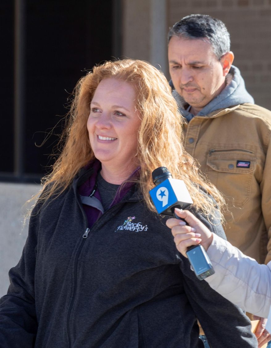 Jenny Cudd, front, a flower shop owner and former Midland mayoral candidate, and Eliel Rosa leave the federal courthouse in Midland, Texas, Wednesday, Jan. 13, 2021. The FBI arrested Cudd and Rosa on Wednesday in connection with the Jan. 6 insurrection at the U.S Capitol. (Tim Fischer/Reporter-Telegram via AP)