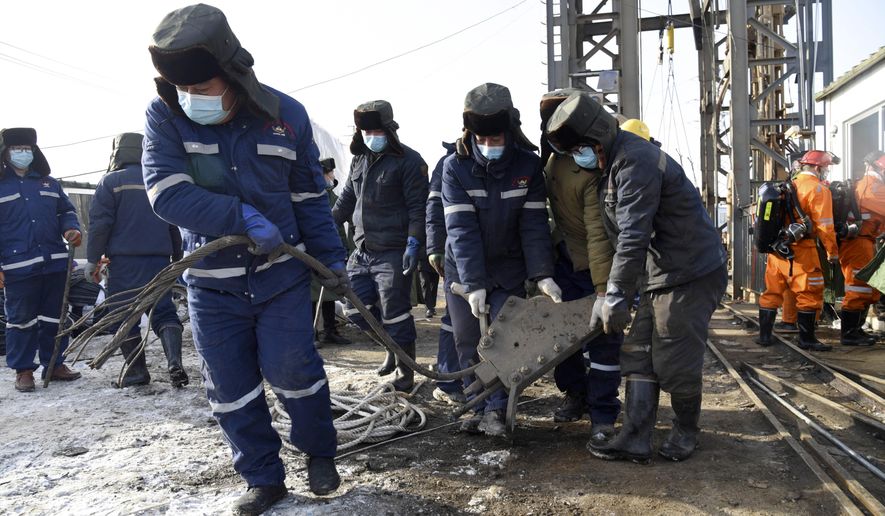 In this photo released by China&#39;s Xinhua News Agency, rescuers work at the site of a gold mine that suffered an explosion in Qixia in eastern China&#39;s Shandong Province, Tuesday, Jan. 12, 2021. Authorities have detained managers at a gold mine in eastern China where more than 20 workers have been trapped underground following an explosion Sunday. (Wang Kai/Xinhua via AP)