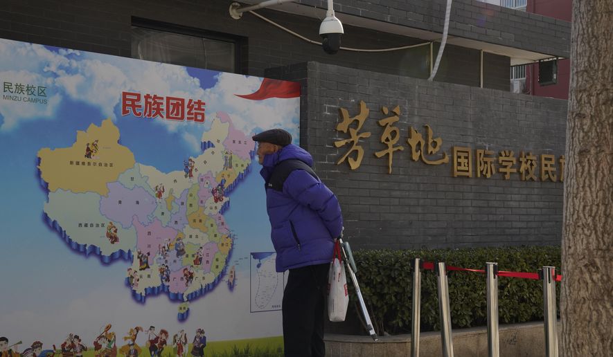 An elderly Chinese man looks at map of Chinese showing its different ethnic groups and the slogan &amp;quot;Ethnic Unity&amp;quot; in Beijing, China Monday, Jan. 11, 2021. A Chinese official on Monday denied Beijing has imposed coercive birth control measures among Muslim minority women, following an outcry over a tweet by the Chinese Embassy in Washington claiming that government polices had freed women of the Uighur ethnic group from being &amp;quot;baby-making machines.&amp;quot; (AP Photo/Ng Han Guan)