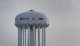 The Flint Water Plant tower is shown in Flint, Mich., Wednesday, Jan. 13, 2021.  Some Flint residents impacted by months of lead-tainted water are looking past expected charges against former Gov. Rick Snyder and others in his administration to healing physical and emotional damages left by the crisis.   (AP Photo/Paul Sancya)