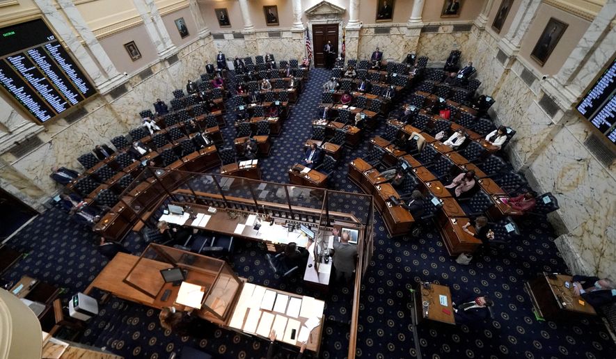 Members of the Maryland House of Representatives are seen socially distanced to prevent the spread of COVID-19 during the first day of the state&#39;s 2021 legislative session, Wednesday, Jan. 13, 2021, in Annapolis, Md. (AP Photo/Julio Cortez)