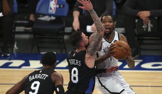 Brooklyn Nets forward Kevin Durant (7) drives to the basket against New York Knicks guards Austin Rivers (8) and RJ Barrett (9) during the first quarter of an NBA basketball game Wednesday, Jan. 13, 2021, in New York. (Brad Penner/Pool Photo via AP)