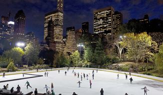 In this Nov. 3, 2016 file photo, skaters take to the ice at Wollman Rink in New York&#x27;s Central Park. New York City will terminate business contracts with President Donald Trump after last week&#x27;s insurrection at the U.S. Capitol, Mayor Bill de Blasio announced Wednesday, Jan. 13, 2021. The Trump Organization is under city contract to operate the two ice rinks and a carousel in Central Park as well as a golf course in the Bronx. (AP Photo/Mark Lennihan, File)