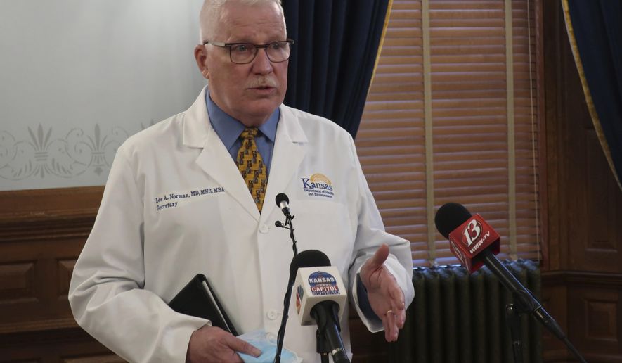 Dr. Lee Norman, head of the Kansas Department of Health and Environment, answers questions about the COVID-19 pandemic during a news conference, Wednesday, Jan. 13, 2021, at the Statehouse in Topeka, Kan. Norman says he's encouraged by data showing that hospitals have been under less stress recently from the pandemic. (AP Photo/John Hanna)