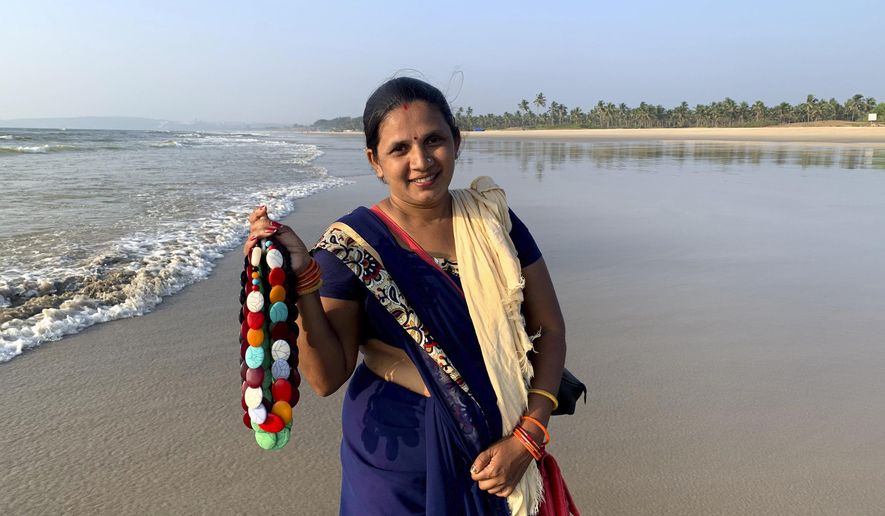Seema Rajgarh, 37, hawks jewelry made of beads and stones on nearly deserted Utorda beach in South Goa, India,, Dec.16, 2020. On good days during the holiday season, the mother of three girls, the youngest not yet two years old, said she used to make 2,000 rupees ( $27). Now, times are bleak. &amp;quot;Some days, I make barely 200 rupees ($2.7), not enough to even buy milk and food for my children,&amp;quot; she said.  &amp;quot;This virus has devastated our lives,&amp;quot; Rajgarh said. Goans are mourning the loss of their livelihoods and possibly their way of life to the pandemic and travel restrictions. (AP Photo/Vineeta Deepak)