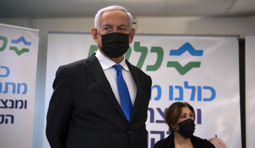 Israeli Prime Minister Benjamin Netanyahu visits a coronavirus vaccination facility in the northern Arab city of Nazareth, Israel, Wednesday, Jan. 13, 2021. (Gil Eliyahu/Pool via AP)