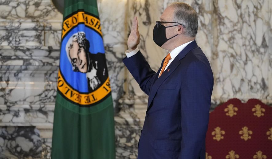Washington Gov. Jay Inslee takes the oath of office for his third term as Governor, Wednesday, Jan. 13, 2021, during a ceremony at the Capitol in Olympia, Wash. (AP Photo/Ted S. Warren)