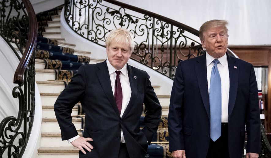 In this Sunday, Aug. 25, 2019, file photo, President Donald Trump and Britain&#39;s Prime Minister Boris Johnson, left, speak to the media before a working breakfast meeting at the Hotel du Palais on the sidelines of the G-7 summit in Biarritz, France. (Erin Schaff, Pool via AP) ** FILE **