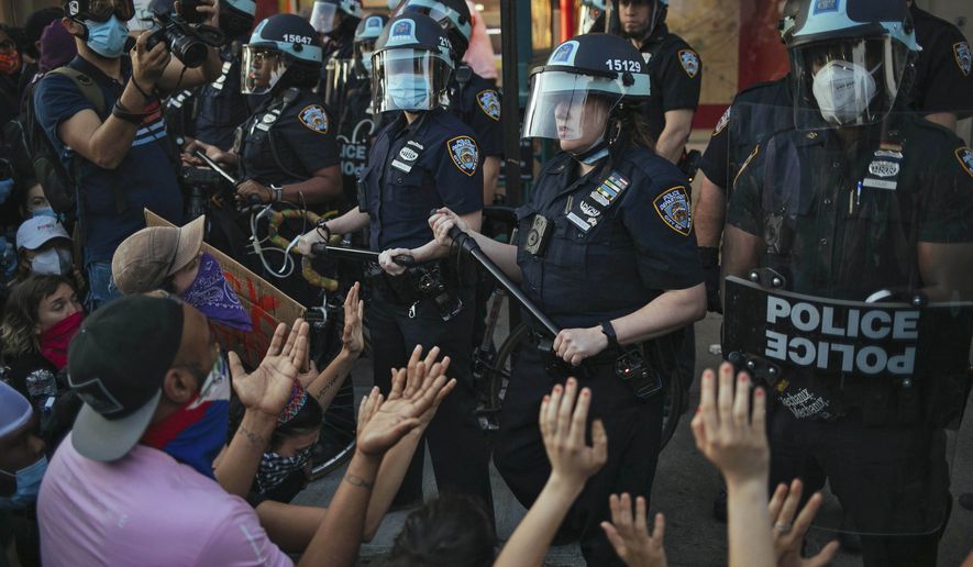 This May 31, 2020, file photo shows New York City Police facing off with activists during a protest march in the Bedford-Stuyvesant section of the Brooklyn borough of New York. New York’s attorney general sued the New York Police Department on Thursday, Jan. 14, 2021, alleging the rough treatment of protesters last spring in the wake of George Floyd’s killing was part of a longstanding pattern of abuse that stemmed from inadequate training, supervision and discipline. (AP Photo/Kevin Hagen, FIle)