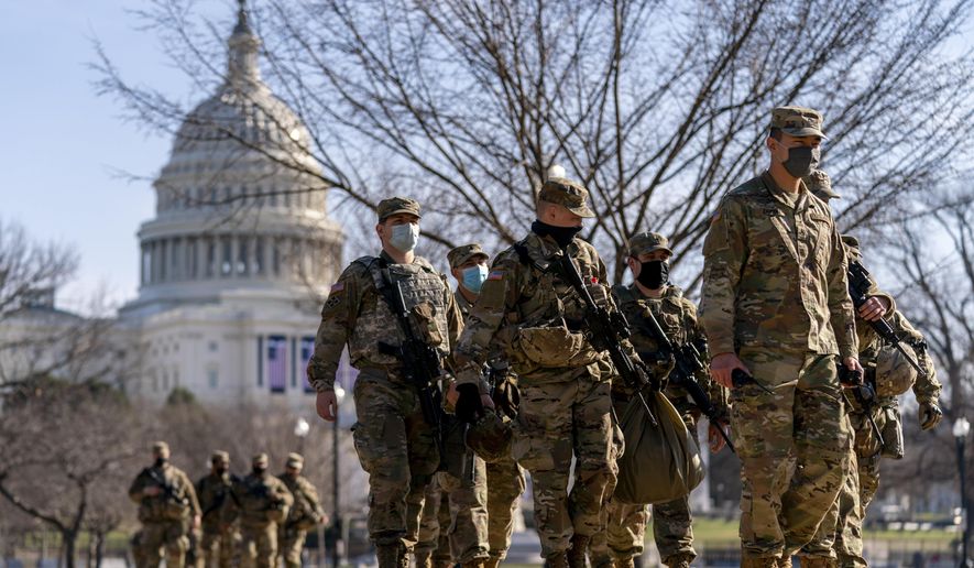 Members of the National Guard patrol outside the Capitol Building on Capitol Hill in Washington, Thursday, Jan. 14, 2021. (AP Photo/Andrew Harnik)