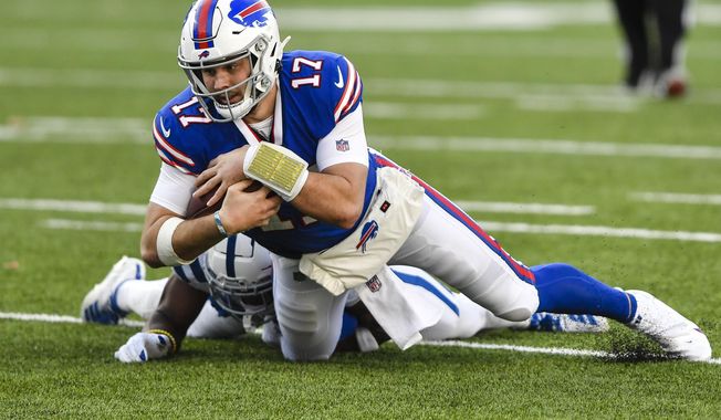 Buffalo Bills quarterback Josh Allen (17) is tackled by Indianapolis Colts&#x27; Kenny Moore II during the second half of an NFL wild-card playoff football game Saturday, Jan. 9, 2021, in Orchard Park, N.Y. (AP Photo/Adrian Kraus)