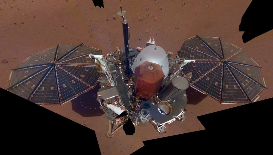 FILE - This Dec. 6, 2018 image made available by NASA shows the InSight lander. The scene was assembled from 11 photos taken using its robotic arm. On Thursday, Jan. 14, 2021, NASA declared the craft dead after failing to burrow deep into the red planet to take its temperature. (NASA via AP)