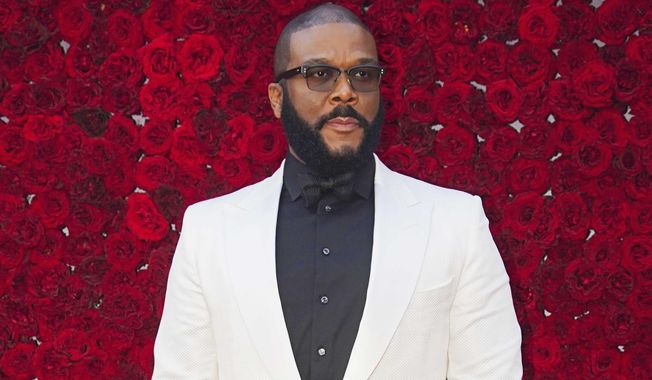 FILE - Tyler Perry poses at the grand opening of Tyler Perry Studios in Atlanta on Oct. 5, 2019.  Perry and the Motion Picture and Television Fund are being honored with the Jean Hersholt Humanitarian Award, the Academy of Motion Picture Arts and Sciences said Thursday. Perry and the MPTF will receive their Oscar statuettes at the 93rd Academy Awards on April 25.  (Photo by Elijah Nouvelage/Invision/AP, File)