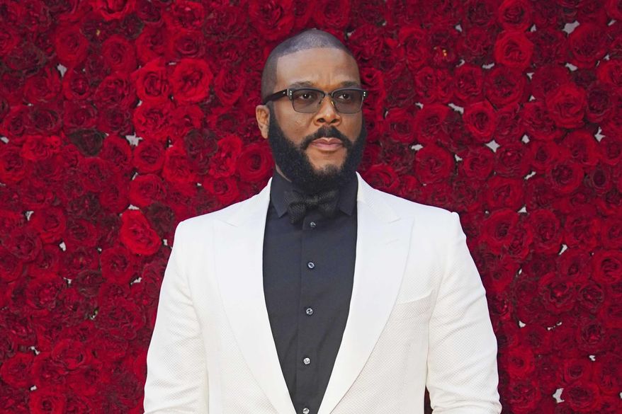 FILE - Tyler Perry poses at the grand opening of Tyler Perry Studios in Atlanta on Oct. 5, 2019.  Perry and the Motion Picture and Television Fund are being honored with the Jean Hersholt Humanitarian Award, the Academy of Motion Picture Arts and Sciences said Thursday. Perry and the MPTF will receive their Oscar statuettes at the 93rd Academy Awards on April 25.  (Photo by Elijah Nouvelage/Invision/AP, File)