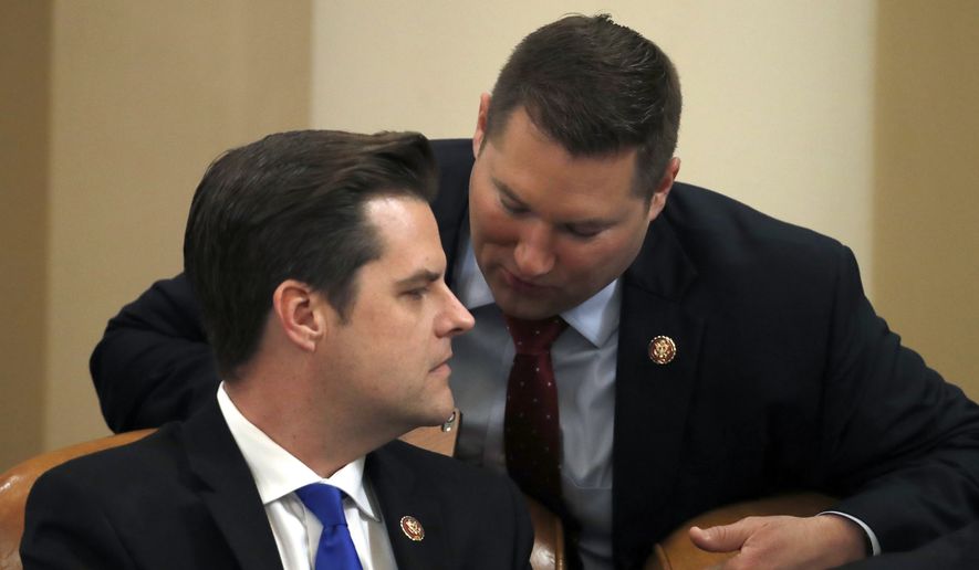 Rep. Matt Gaetz, R-Fla., left, speaks with Rep. Andy Biggs, R-Ariz., during a House Judiciary Committee markup of the articles of impeachment against President Donald Trump, on Capitol Hill Thursday, Dec. 12, 2019, in Washington. (AP Photo/Alex Brandon) **FILE**