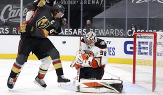 Anaheim Ducks goalie John Gibson (36) blocks a shot as Vegas Golden Knights right wing Mark Stone (61) looks for the rebound during the second period of an NHL hockey game Tuesday, Jan. 14, 2020, in Las Vegas. (AP Photo/Isaac Brekken)