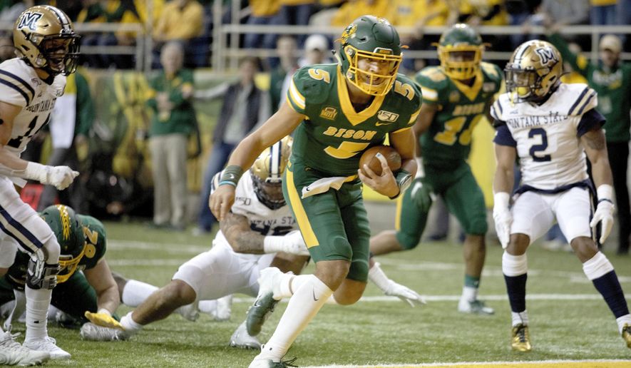 FILE - In this Dec. 21, 2019, file photo, North Dakota State quarterback Trey Lance (5) scores a rushing touchdown during the first half of an FCS playoff NCAA college football game against Montana State in Fargo, N.D. All but a few teams in the Football Championship Subdivision shut down in the fall because of the COVID-19 pandemic and will play a spring season culminating with the NCAA playoffs in April and May. (AP Photo/Bruce Crummy, File)