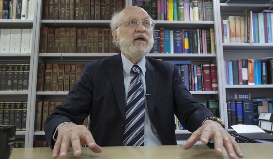 John Clancey, an American lawyer who became the first foreigner arrested under Hong Kong's national security law, speaks during an interview in Hong Kong, Friday, Jan. 15, 2021. Clancey said Friday that the courts now have a choice between the new law and the city's legally enshrined freedoms, as China cracks down on dissent in the Asian financial capital. (AP Photo/Kin Cheung)