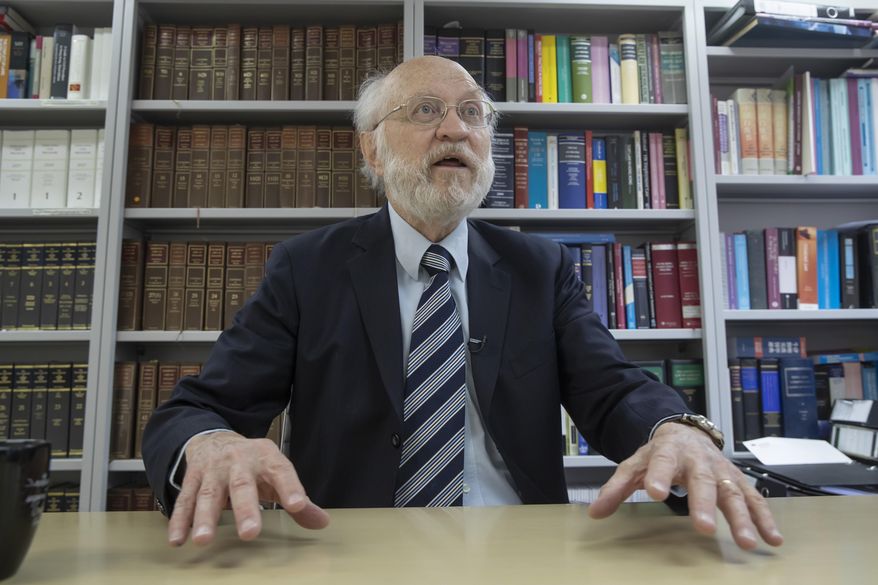 John Clancey, an American lawyer who became the first foreigner arrested under Hong Kong's national security law, speaks during an interview in Hong Kong, Friday, Jan. 15, 2021. Clancey said Friday that the courts now have a choice between the new law and the city's legally enshrined freedoms, as China cracks down on dissent in the Asian financial capital. (AP Photo/Kin Cheung)