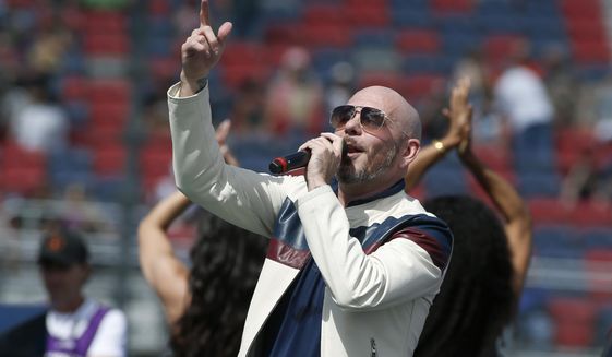 FILE - Pitbull performs prior to a NASCAR Cup Series auto race at Phoenix Raceway in Avondale Ariz., in this Sunday, March 8, 2020, file photo. New NASCAR team Trackhouse Racing has brought entertainer Pitbull on as an ownership partner for an organization making its debut next month at the Daytona 500.  “Mr. Worldwide” joins NBA Hall of Famer Michael Jordan as celebrity owners entering NASCAR this year. (AP Photo/Ralph Freso, File)