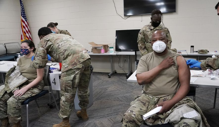 FILE - In this Dec. 23, 2020, file photo, members of the Mississippi Air and Army National Guard Guard receive the first dose of the Moderna COVID-19 vaccine in Flowood, Miss. The coronavirus vaccines have been rolled out unevenly across the U.S., but some states in the Deep South have had particularly dismal inoculation rates. (AP Photo/Rogelio V. Solis, File)