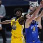 Denver Nuggets center Nikola Jokic, front, drives to the rim for a reverse dunk basket past Golden State Warriors center James Wiseman in the first half of an NBA basketball game Thursday, Jan. 14, 2021, in Denver. (AP Photo/David Zalubowski)