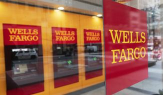 A Wells Fargo office is shown, Wednesday, Jan. 13, 2021 in New York.  Wells Fargo &amp;amp; Co. says its profit rose 4% to $2.99 billion in the fourth quarter of 2020. The bank, based in San Francisco, said Friday that it had earnings of 64 cents per share, compared with earnings of 60 cents a year earlier. (AP Photo/Mark Lennihan)
