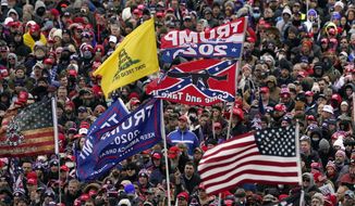 Photos and video of the Capitol assault showed rioters with clothing, emblems and flags identifying themselves as members of the conspiracy group QAnon, the loosely allied alt-right America First group, and militias such as Three Percenters, the Proud Boys and the Oath Keepers. (Associated Press/File)