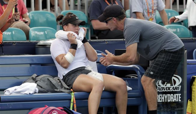 In this March 21, 2019 file photo, Bianca Andreescu, of Canada, left, talks with her coach Sylvain Bruneau during her match against Irina Camelia Begu, of Romania, at the Miami Open tennis tournament in Miami Gardens, Fla. Bruneau has released a statement, Sunday, Jan. 17, 2021, saying he was the positive coronavirus case aboard the flight from Abu Dhabi to Melbourne and he had followed all protocols and procedures, including producing a negative test within 72 hours before the flight departure and has &amp;quot;no idea how I might have contracted the virus.&amp;quot; (AP Photo/Lynne Sladky, File) **FILE**