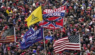 In this Wednesday, Jan. 6, 2021, file photo, supporters listen as President Donald Trump speaks as a Confederate-themed and other flags flutter in the wind during a rally in Washington. (AP Photo/Evan Vucci, File)