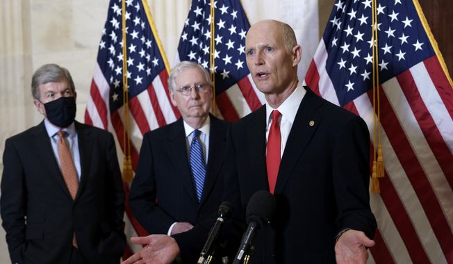 In this Nov. 10, 2020, file photo Sen. Rick Scott, R-Fla., by Senate Majority Leader Mitch McConnell, R-Ky., and Sen. Roy Blunt, R-Mo., left, speaks to reporters briefly following a closed-door meeting where the Republican Conference held leadership elections, on Capitol Hill in Washington. (AP Photo/J. Scott Applewhite, File)