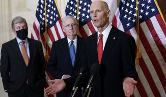 FILE - In this Nov. 10, 2020, file photo Sen. Rick Scott, R-Fla., joined at center by Senate Majority Leader Mitch McConnell, R-Ky., and Sen. Roy Blunt, R-Mo., far left, speaks to reporters briefly following a closed-door meeting where the Republican Conference held leadership elections, on Capitol Hill in Washington. (AP Photo/J. Scott Applewhite, File)