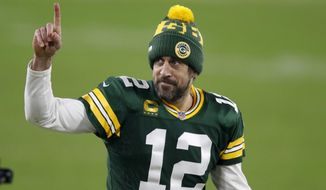 Green Bay Packers quarterback Aaron Rodgers gestures to fans after an NFL divisional playoff football game against the Los Angeles Rams Saturday, Jan. 16, 2021, in Green Bay, Wis. The Packers defeated the Rams 32-18 to advance to the NFC championship game. (AP Photo/Matt Ludtke)