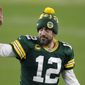 Green Bay Packers quarterback Aaron Rodgers gestures to fans after an NFL divisional playoff football game against the Los Angeles Rams Saturday, Jan. 16, 2021, in Green Bay, Wis. The Packers defeated the Rams 32-18 to advance to the NFC championship game. (AP Photo/Matt Ludtke)