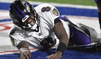 Baltimore Ravens quarterback Lamar Jackson (8) reacts after getting hurt during the second half of an NFL divisional round football game against the Buffalo Bills Saturday, Jan. 16, 2021, in Orchard Park, N.Y. (AP Photo/Adrian Kraus)