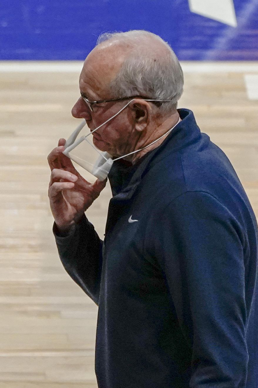 Syracuse head coach Jim Boeheim adjusts his mask as his team plays against Pittsburgh during the first half of an NCAA college basketball game, Saturday, Jan. 16, 2021, in Pittsburgh. Pittsburgh won 96-76. (AP Photo/Keith Srakocic)