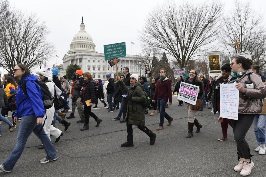 FILE - In this Friday, Jan. 24, 2020 file photo, anti-abortion activists participate in the "March for Life" rally near Capitol Hill in Washington. Organizers of the March for Life, the anti-abortion movement’s preeminent annual event, are asking their supporters nationwide not to gather in Washington in 2021 due to the COVID-19 pandemic and political unrest. (AP Photo/Susan Walsh)