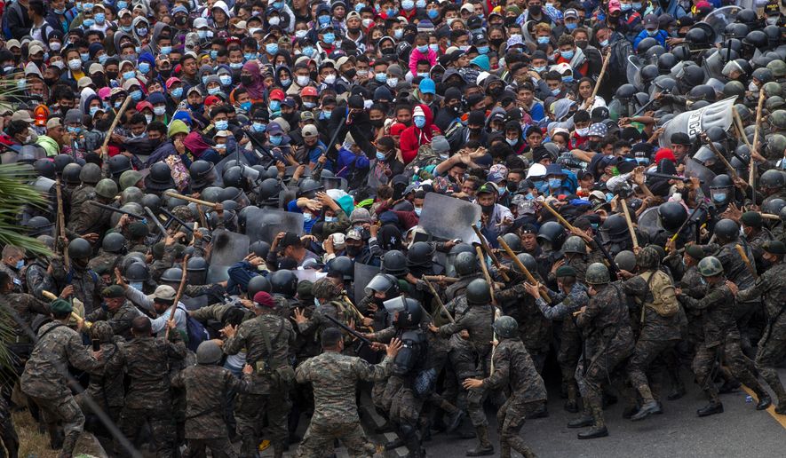 Honduran migrants clash with Guatemalan soldiers in Vado Hondo, Guatemala, Sunday, Jan. 17, 2021. Guatemalan authorities estimated that as many as 9,000 Honduran migrants crossed into Guatemala as part of an effort to form a new caravan to reach the U.S. border. (AP Photo/Sandra Sebastian)