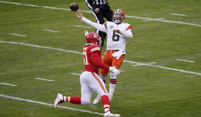 Cleveland Browns quarterback Baker Mayfield (6) throws a pass over Kansas City Chiefs defensive end Mike Danna during the first half of an NFL divisional round football game, Sunday, Jan. 17, 2021, in Kansas City. (AP Photo/Orlin Wagner)