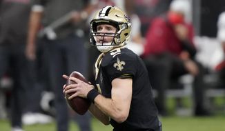 New Orleans Saints quarterback Drew Brees (9) works against the Tampa Bay Buccaneers during the first half of an NFL divisional round playoff football game, Sunday, Jan. 17, 2021, in New Orleans. (AP Photo/Brynn Anderson)
