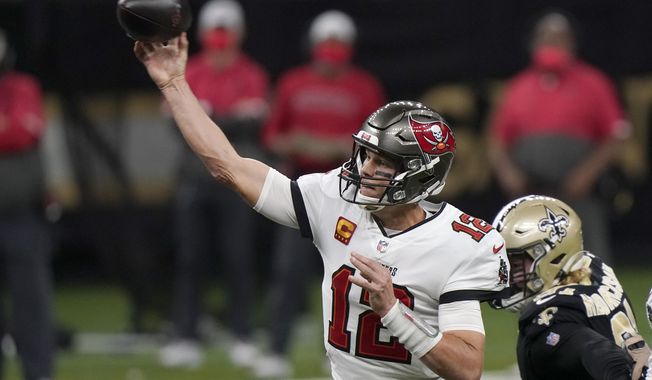 Tampa Bay Buccaneers quarterback Tom Brady (12) works against the New Orleans Saints during the first half of an NFL divisional round playoff football game, Sunday, Jan. 17, 2021, in New Orleans. (AP Photo/Brynn Anderson)