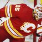 Calgary Flames goalie Jacob Markstrom eyes the puck  during the third period of the team&#39;s NHL hockey game against the Vancouver Canucks on Saturday, Jan. 16, 2021, in Calgary, Alberta. (Jeff McIntosh/The Canadian Press via AP)