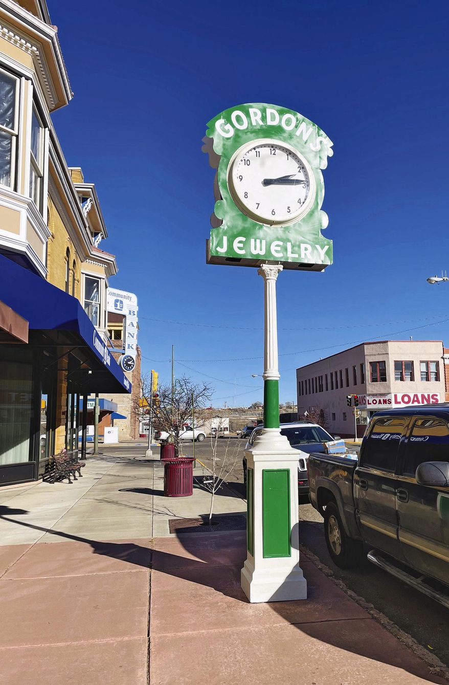 ADVANCE FOR PUBLICATION ON SUNDAY, JAN. 17, AND THEREAFTER - This undated image shows a piece of Las Vegas' history, the Gordon's Jewelry electric clock, in its original location near the intersection of Douglas Avenue and Sixth Street in Las Vegas, New Mexico. The clock's restoration was started by Bob Miser before he died in 2020. The project was completed by the Las Vegas New Mexico Community Foundation. (Phil Scherer/The Daily Optic via AP)
