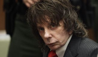 In this May 29, 2009, file photo, music producer Phil Spector sits in a courtroom for his sentencing in Los Angeles. Spector, the eccentric and revolutionary music producer who transformed rock music with his “Wall of Sound” method and who was later convicted of murder, died Saturday, Jan. 16, 2021, at age 81. (AP Photo/Jae C. Hong, Pool, File)