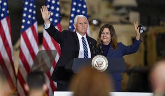 Vice President Mike Pence, left, and second lady Karen Pence wave following remarks to Army 10th Mountain Division soldiers, many of whom have recently returned from Afghanistan, in Fort Drum, N.Y., Sunday, Jan. 17, 2021. (AP Photo/Adrian Kraus)
