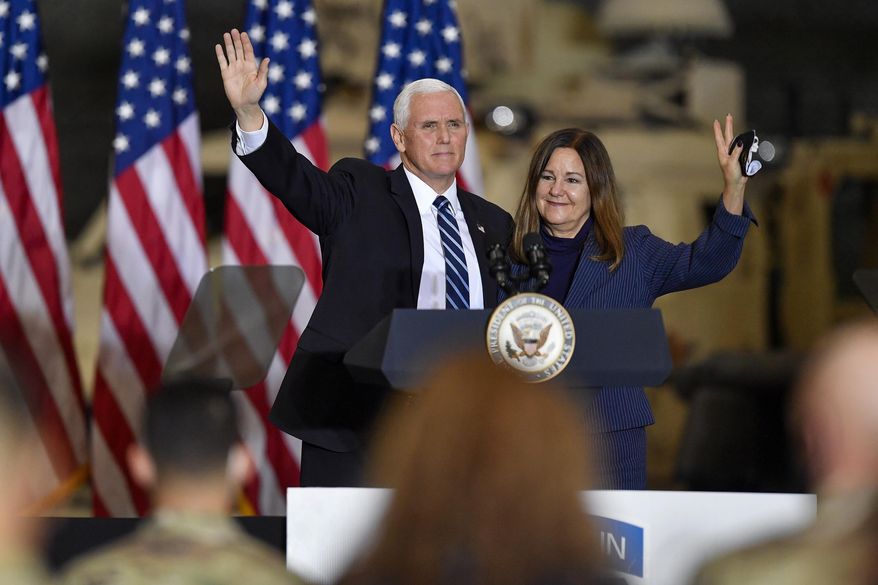 Vice President Mike Pence, left, and second lady Karen Pence wave following remarks to Army 10th Mountain Division soldiers, many of whom have recently returned from Afghanistan, in Fort Drum, N.Y., Sunday, Jan. 17, 2021. (AP Photo/Adrian Kraus)
